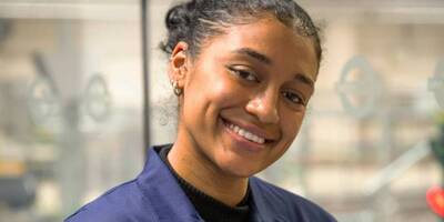 Female apprentice smiling at camera