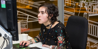 A young lady using a computer in an office